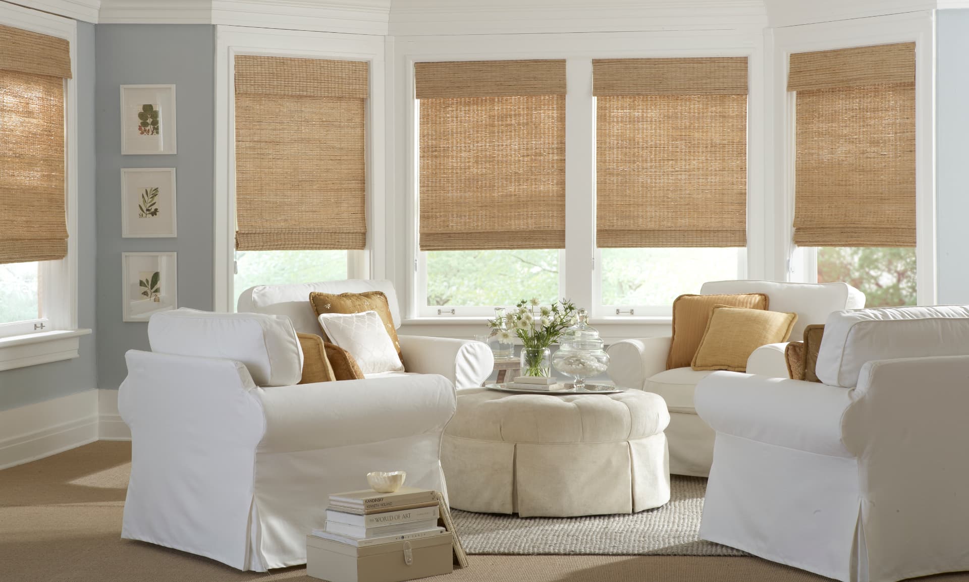 Natural woven wood roman shades in a bright living room