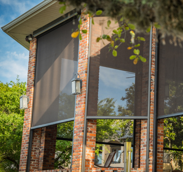 Motorized exterior patio shade enclosing a covered Houston patio